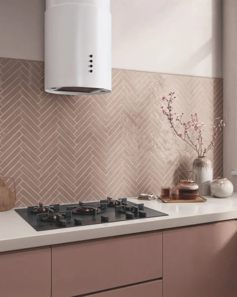 White cylinder hood against a pink wall, which is a braver call than the tile.