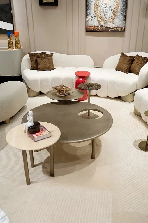 Layered Living Room Setup: Curved Sofas and 2 Coffee Tables